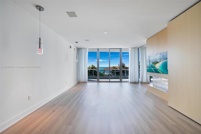 5959 Collins Ave Unit 705, Miami Beach, FL 33140 - unfurnished room featuring floor to ceiling windows and light wood-style flooring