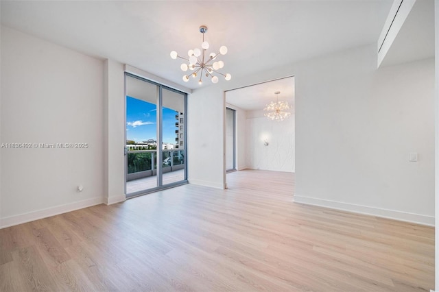 5959 Collins Ave Unit 705, Miami Beach, FL 33140 - empty room with a chandelier, light wood-style flooring, and floor to ceiling windows
