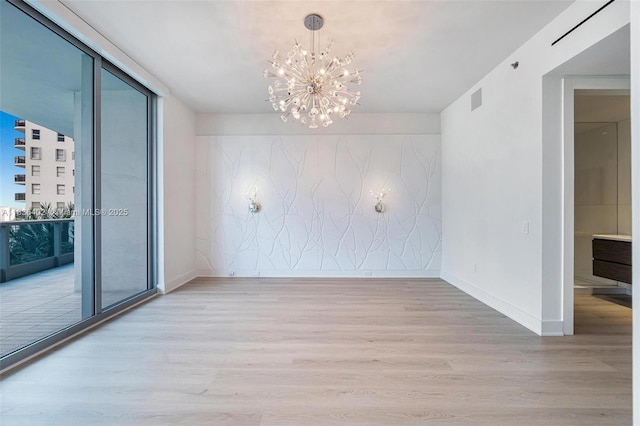 5959 Collins Ave Unit 705, Miami Beach, FL 33140 - unfurnished dining area featuring wood finished floors, a chandelier, and healthy amount of natural light