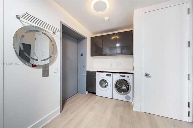 5959 Collins Ave Unit 705, Miami Beach, FL 33140 - laundry area featuring cabinet space, washing machine and dryer, and light wood-style flooring