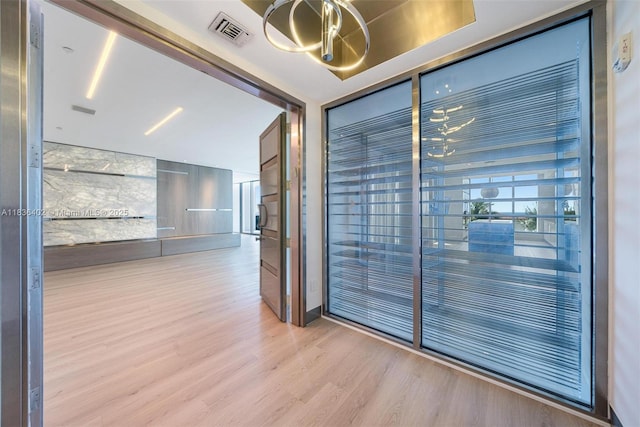 5959 Collins Ave Unit 705, Miami Beach, FL 33140 - spare room with wood finished floors and a chandelier