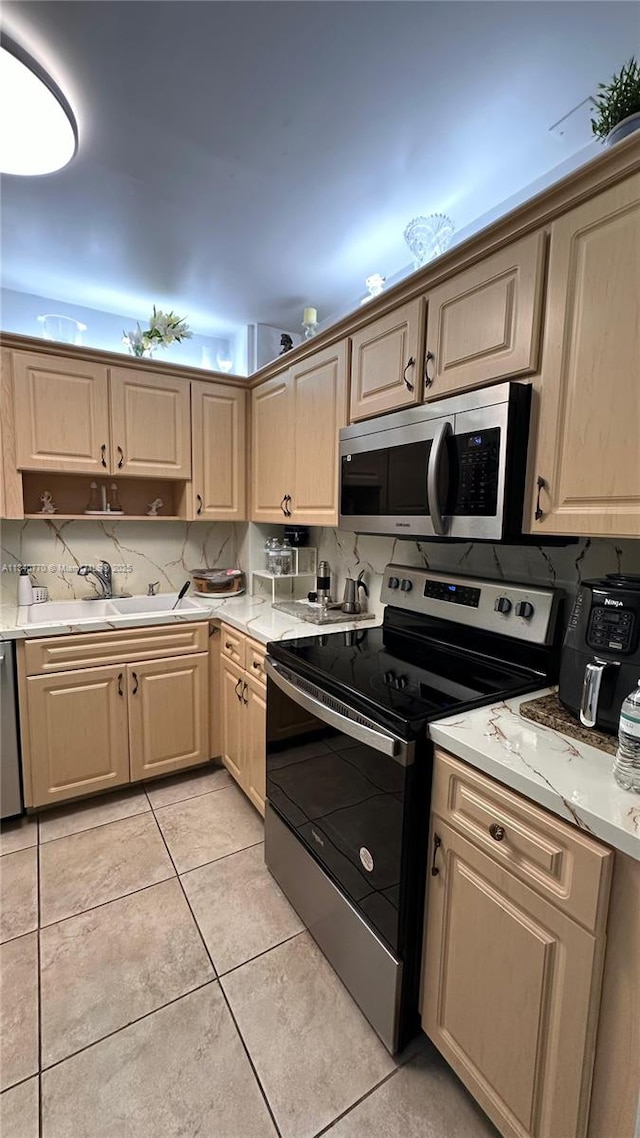 4001 Hillcrest Dr Unit 705, Hollywood, FL 33021 - kitchen featuring appliances with stainless steel finishes, light countertops, light tile patterned floors, and light brown cabinets