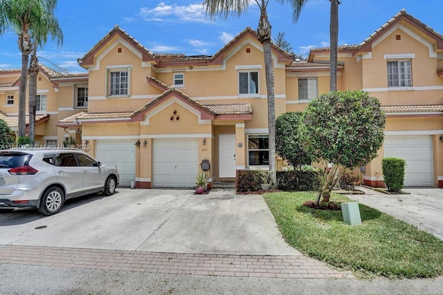 8657 SW 22nd Ct, Miramar, FL 33025 - mediterranean / spanish-style house with an attached garage, driveway, stucco siding, and a tiled roof