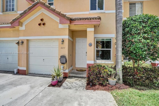 8657 SW 22nd Ct, Miramar, FL 33025 - entrance to property featuring stucco siding, driveway, and an attached garage