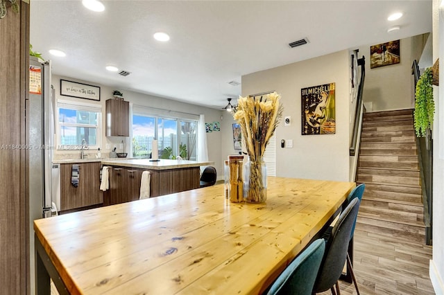 8657 SW 22nd Ct, Miramar, FL 33025 - kitchen featuring recessed lighting, light wood-style flooring, a kitchen island, a kitchen bar, and freestanding refrigerator