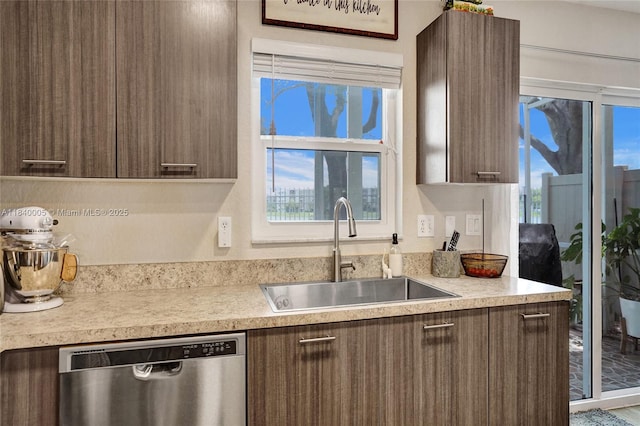 8657 SW 22nd Ct, Miramar, FL 33025 - kitchen with modern cabinets, stainless steel dishwasher, light countertops, and dark brown cabinets