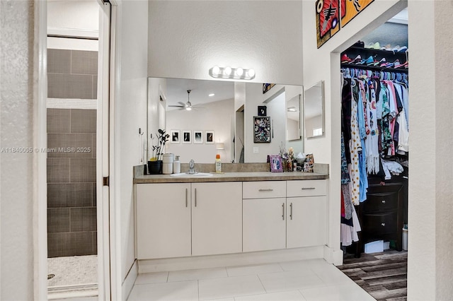 8657 SW 22nd Ct, Miramar, FL 33025 - full bathroom with vanity, a ceiling fan, a stall shower, tile patterned floors, and a spacious closet