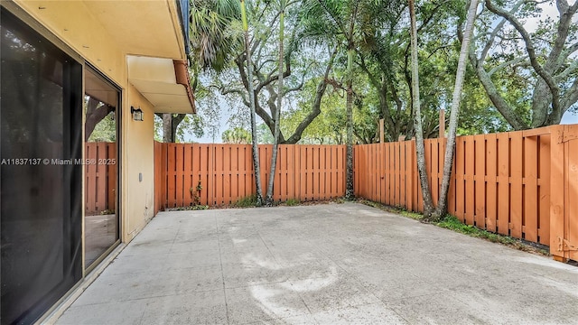 135 Heritage Way, West Palm Beach, FL 33407 - fenced backyard featuring a patio area