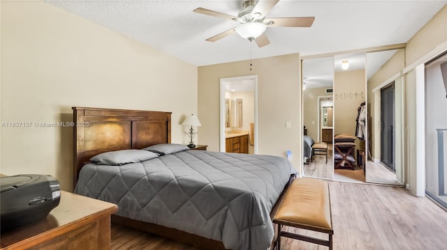 135 Heritage Way, West Palm Beach, FL 33407 - bedroom featuring wood finished floors, ensuite bath, and a ceiling fan