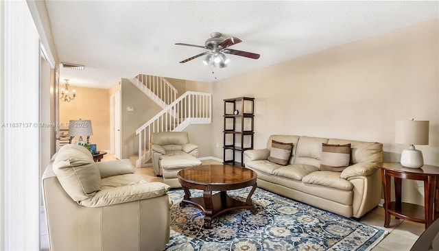 135 Heritage Way, West Palm Beach, FL 33407 - living room featuring stairway, a ceiling fan, a textured ceiling, and a chandelier