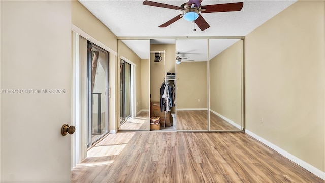 135 Heritage Way, West Palm Beach, FL 33407 - empty room featuring ceiling fan, wood finished floors, and a textured ceiling