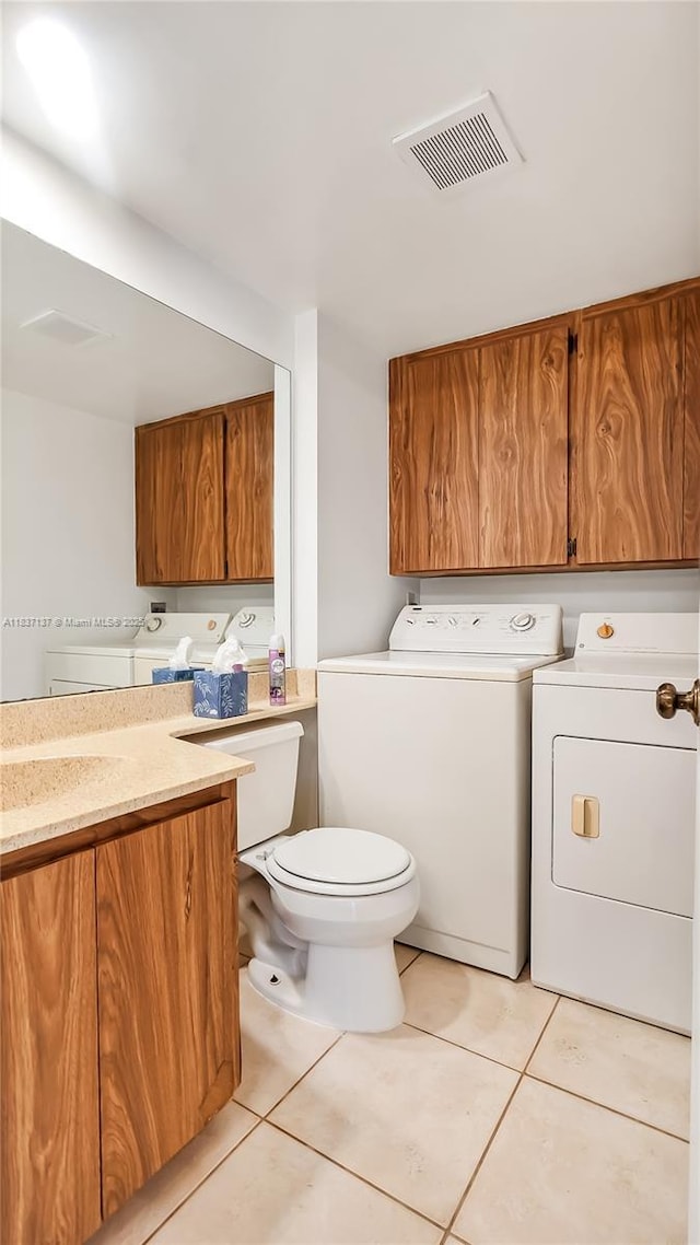 135 Heritage Way, West Palm Beach, FL 33407 - bathroom with washing machine and clothes dryer, tile patterned floors, and vanity