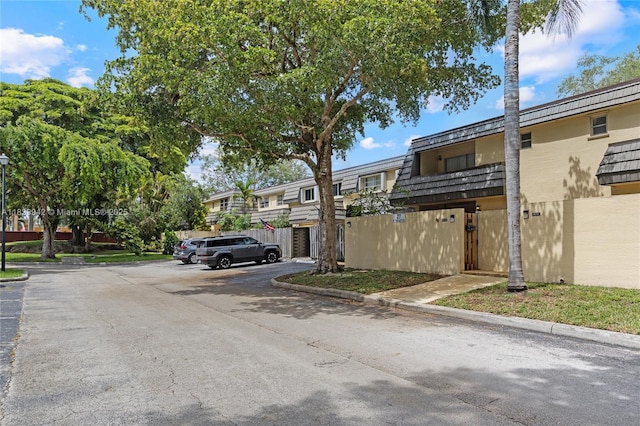 8713 SW 137th Ave Unit 8713, Miami, FL 33183 - view of asphalt street featuring curbs, a residential view, and street lights