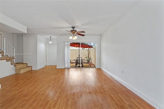 8713 SW 137th Ave Unit 8713, Miami, FL 33183 - unfurnished living room featuring a ceiling fan, light wood-type flooring, and stairway