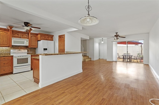 8713 SW 137th Ave Unit 8713, Miami, FL 33183 - kitchen featuring ceiling fan, white appliances, backsplash, light wood finished floors, and hanging light fixtures