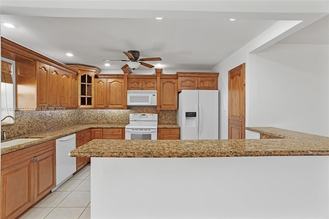 8713 SW 137th Ave Unit 8713, Miami, FL 33183 - kitchen with white appliances, tasteful backsplash, a ceiling fan, glass insert cabinets, and brown cabinets