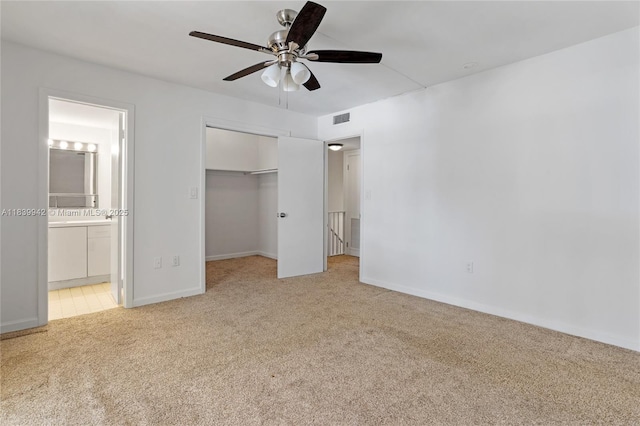8713 SW 137th Ave Unit 8713, Miami, FL 33183 - unfurnished bedroom featuring light carpet, connected bathroom, a ceiling fan, and a spacious closet