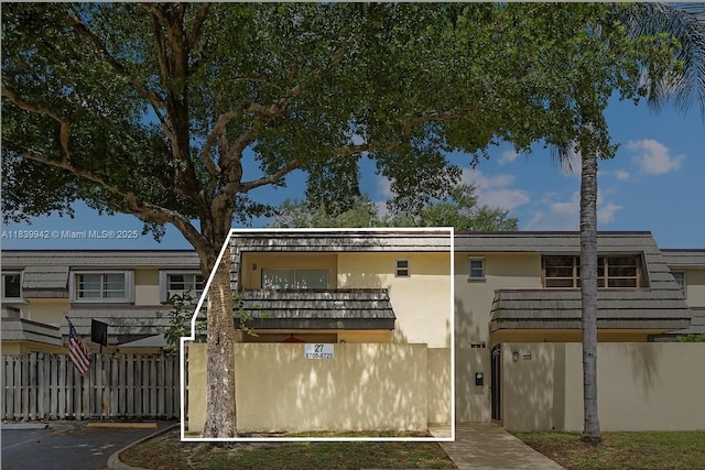 8713 SW 137th Ave Unit 8713, Miami, FL 33183 - view of front of house featuring stucco siding, a balcony, and uncovered parking