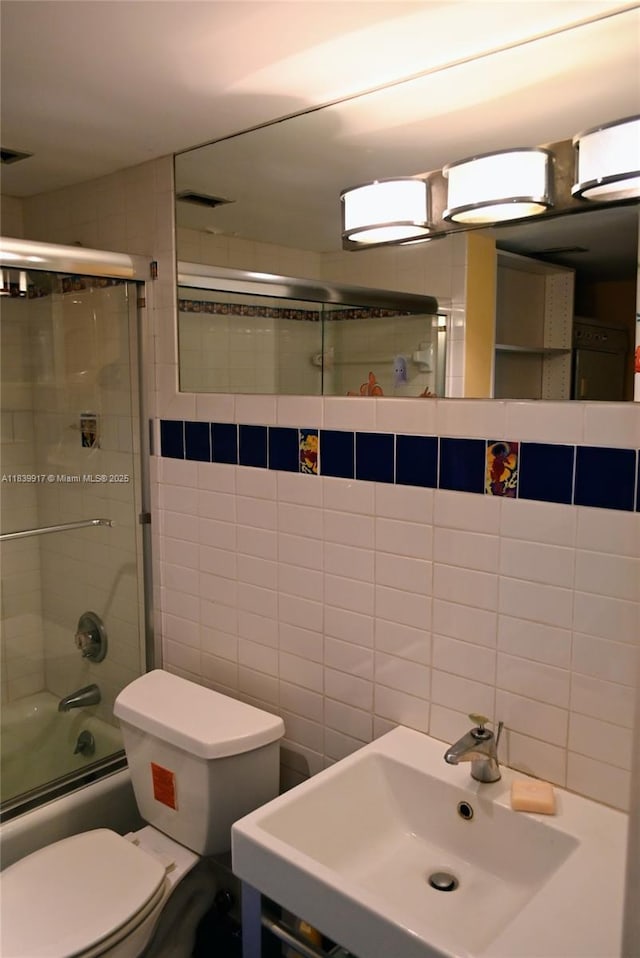 2100 W Sans Souci Blvd Unit E1, North Miami, FL 33181 - full bathroom featuring combined bath / shower with glass door and tile walls