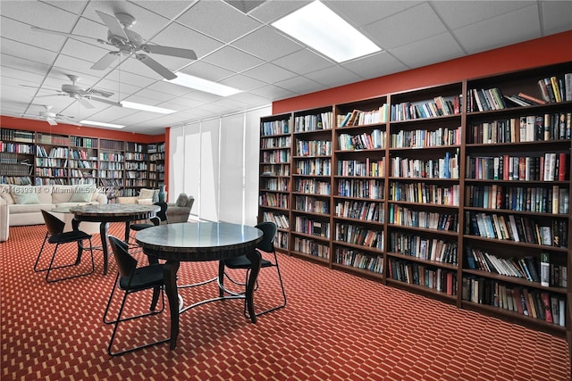 2100 W Sans Souci Blvd Unit E1, North Miami, FL 33181 - miscellaneous room featuring bookshelves, carpet flooring, a paneled ceiling, and a ceiling fan