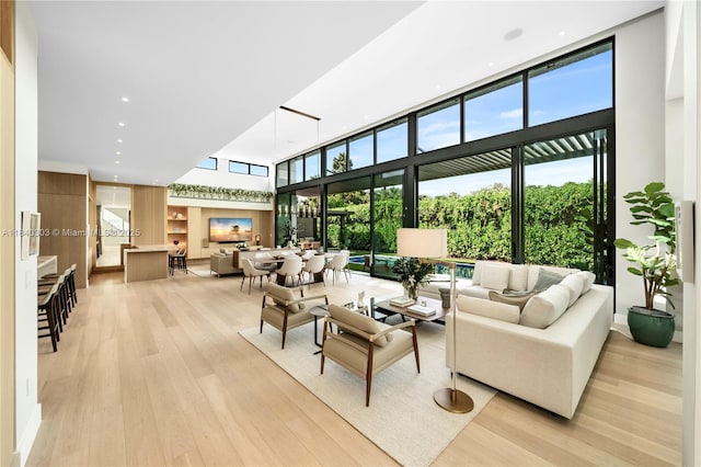 967 NE 117th St, Biscayne Park, FL 33161 - living room featuring a high ceiling and light wood finished floors