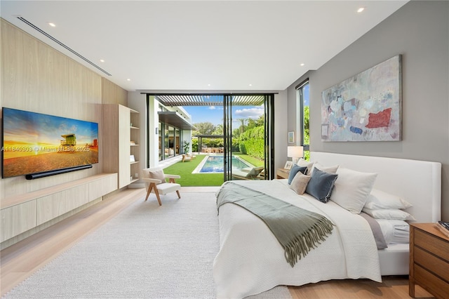 967 NE 117th St, Biscayne Park, FL 33161 - bedroom featuring wood finished floors, access to outside, recessed lighting, and floor to ceiling windows