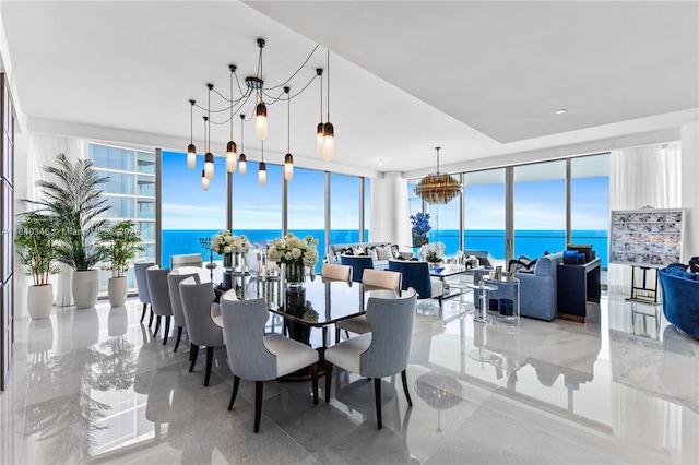 17901 Collins Ave Unit Ts4205, Sunny Isles Beach, FL 33160 - dining room featuring a wall of windows, a chandelier, healthy amount of natural light, and a water view