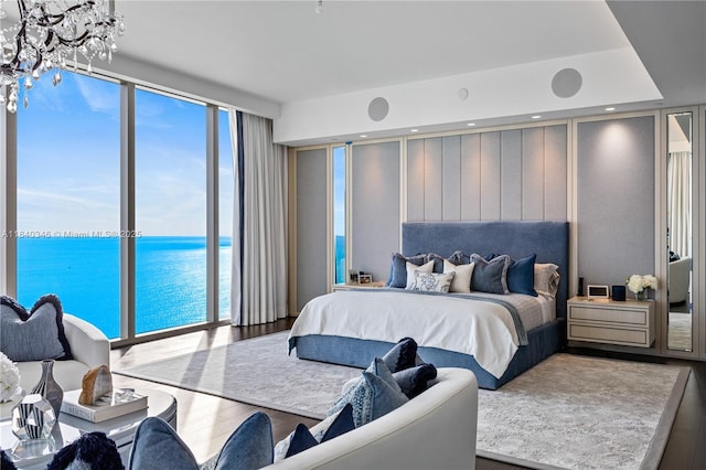 17901 Collins Ave Unit Ts4205, Sunny Isles Beach, FL 33160 - bedroom with a water view, a chandelier, wood finished floors, and access to outside