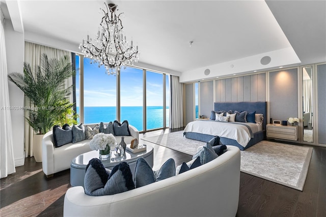17901 Collins Ave Unit Ts4205, Sunny Isles Beach, FL 33160 - bedroom featuring a wall of windows, a chandelier, a water view, and wood finished floors