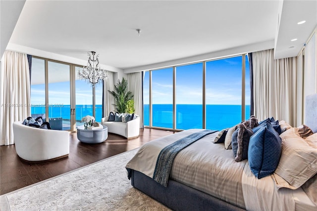 17901 Collins Ave Unit Ts4205, Sunny Isles Beach, FL 33160 - bedroom featuring wood finished floors, floor to ceiling windows, a chandelier, multiple windows, and a water view