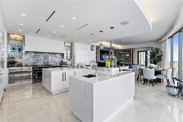 17901 Collins Ave Unit Ts4205, Sunny Isles Beach, FL 33160 - kitchen with a large island with sink, modern cabinets, decorative backsplash, light marble finish flooring, and recessed lighting