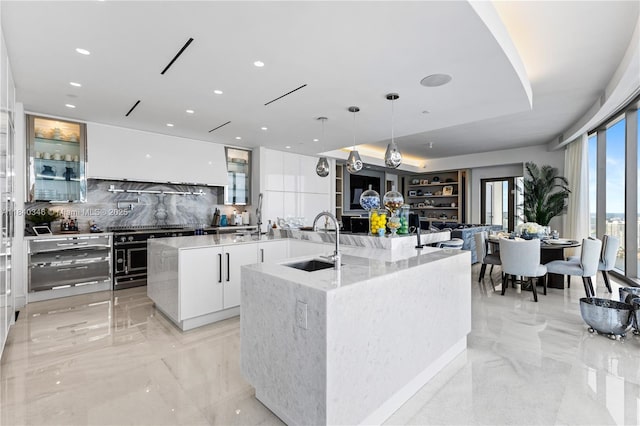 17901 Collins Ave Unit Ts4205, Sunny Isles Beach, FL 33160 - kitchen with modern cabinets, a spacious island, tasteful backsplash, light marble finish flooring, and white cabinets