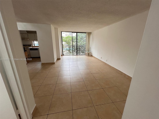 16919 N Bay Rd Unit 204, Sunny Isles Beach, FL 33160 - empty room featuring light tile patterned floors, a textured ceiling, and floor to ceiling windows