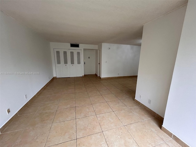 16919 N Bay Rd Unit 204, Sunny Isles Beach, FL 33160 - spare room with light tile patterned floors and baseboards