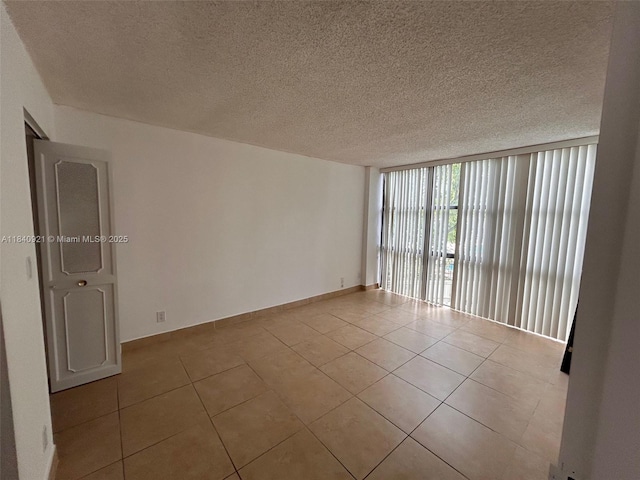 16919 N Bay Rd Unit 204, Sunny Isles Beach, FL 33160 - spare room featuring a wall of windows, tile patterned floors, and a textured ceiling