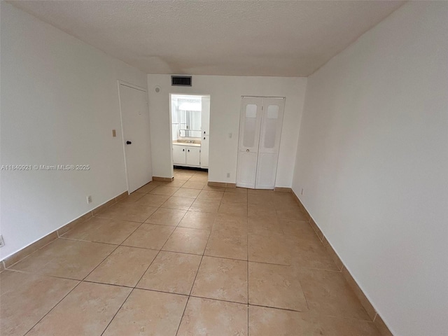 16919 N Bay Rd Unit 204, Sunny Isles Beach, FL 33160 - unfurnished bedroom featuring light tile patterned floors and ensuite bathroom