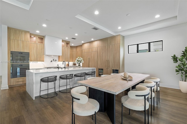 13467 Artisan Cir, Palm Beach Gardens, FL 33418 - dining room featuring recessed lighting, dark wood-type flooring, and a raised ceiling