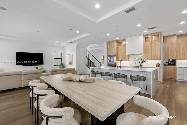 13467 Artisan Cir, Palm Beach Gardens, FL 33418 - dining space featuring stairs, recessed lighting, and wood finished floors