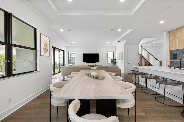 13467 Artisan Cir, Palm Beach Gardens, FL 33418 - dining space with a raised ceiling, recessed lighting, dark wood finished floors, and stairs