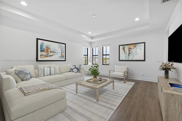 13467 Artisan Cir, Palm Beach Gardens, FL 33418 - living room with dark wood-style floors, recessed lighting, and a tray ceiling