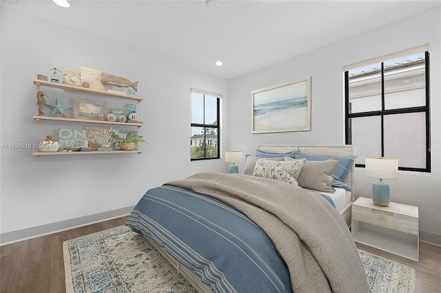 13467 Artisan Cir, Palm Beach Gardens, FL 33418 - bedroom featuring multiple windows, wood finished floors, and recessed lighting
