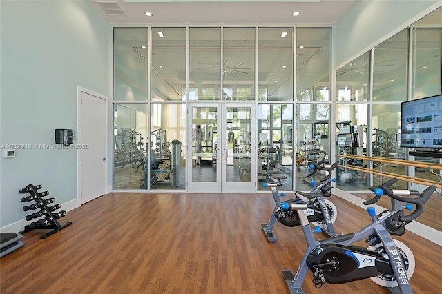 13467 Artisan Cir, Palm Beach Gardens, FL 33418 - gym featuring floor to ceiling windows, french doors, and wood finished floors