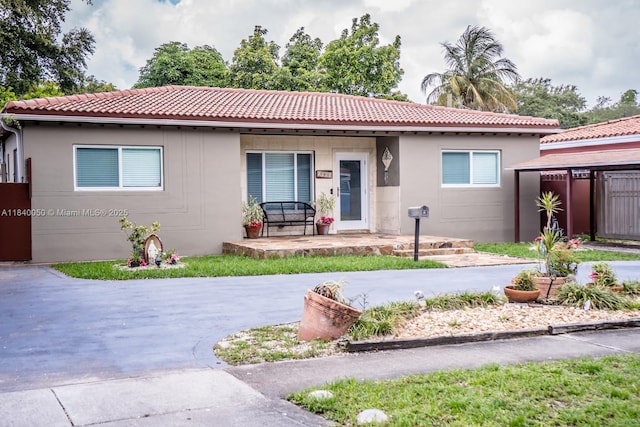 1004 NE 151st Ter, North Miami Beach, FL 33162 - view of front of home with a tile roof and stucco siding