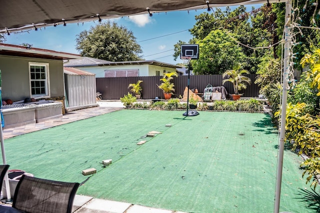 1004 NE 151st Ter, North Miami Beach, FL 33162 - fenced backyard with a putting area