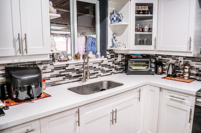 1004 NE 151st Ter, North Miami Beach, FL 33162 - kitchen featuring white cabinetry, decorative backsplash, and light countertops