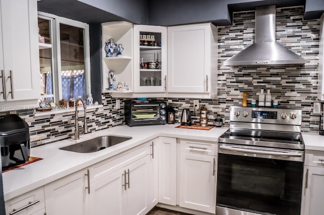 1004 NE 151st Ter, North Miami Beach, FL 33162 - kitchen featuring electric range, wall chimney range hood, backsplash, and light countertops