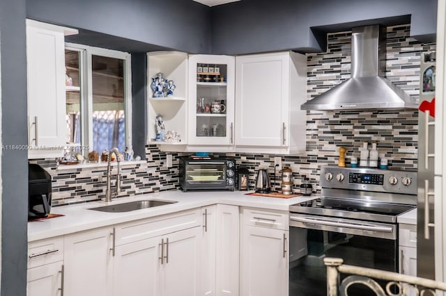 1004 NE 151st Ter, North Miami Beach, FL 33162 - kitchen featuring stainless steel range with electric cooktop, wall chimney range hood, tasteful backsplash, and light countertops