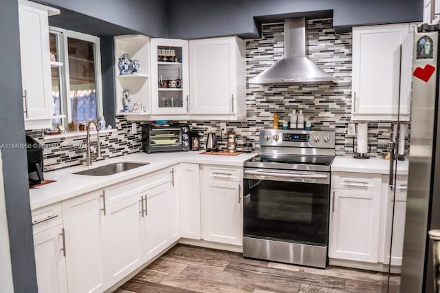 1004 NE 151st Ter, North Miami Beach, FL 33162 - kitchen with stainless steel appliances, wall chimney exhaust hood, backsplash, light countertops, and white cabinetry