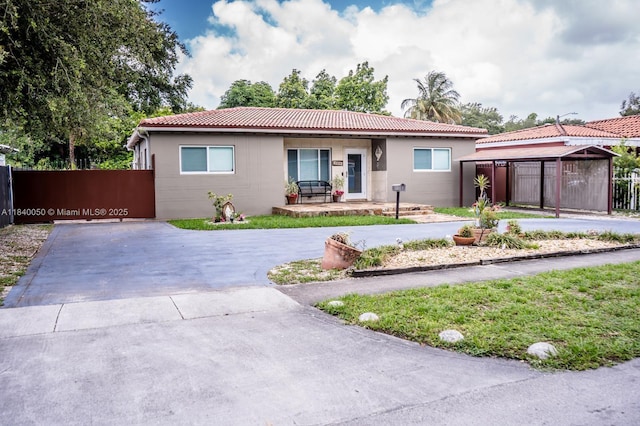 1004 NE 151st Ter, North Miami Beach, FL 33162 - ranch-style home featuring curved driveway and a tiled roof