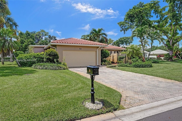 53 Northwoods Ln, Boynton Beach, FL 33436 - mediterranean / spanish-style home with a garage, stucco siding, decorative driveway, a front yard, and a tiled roof